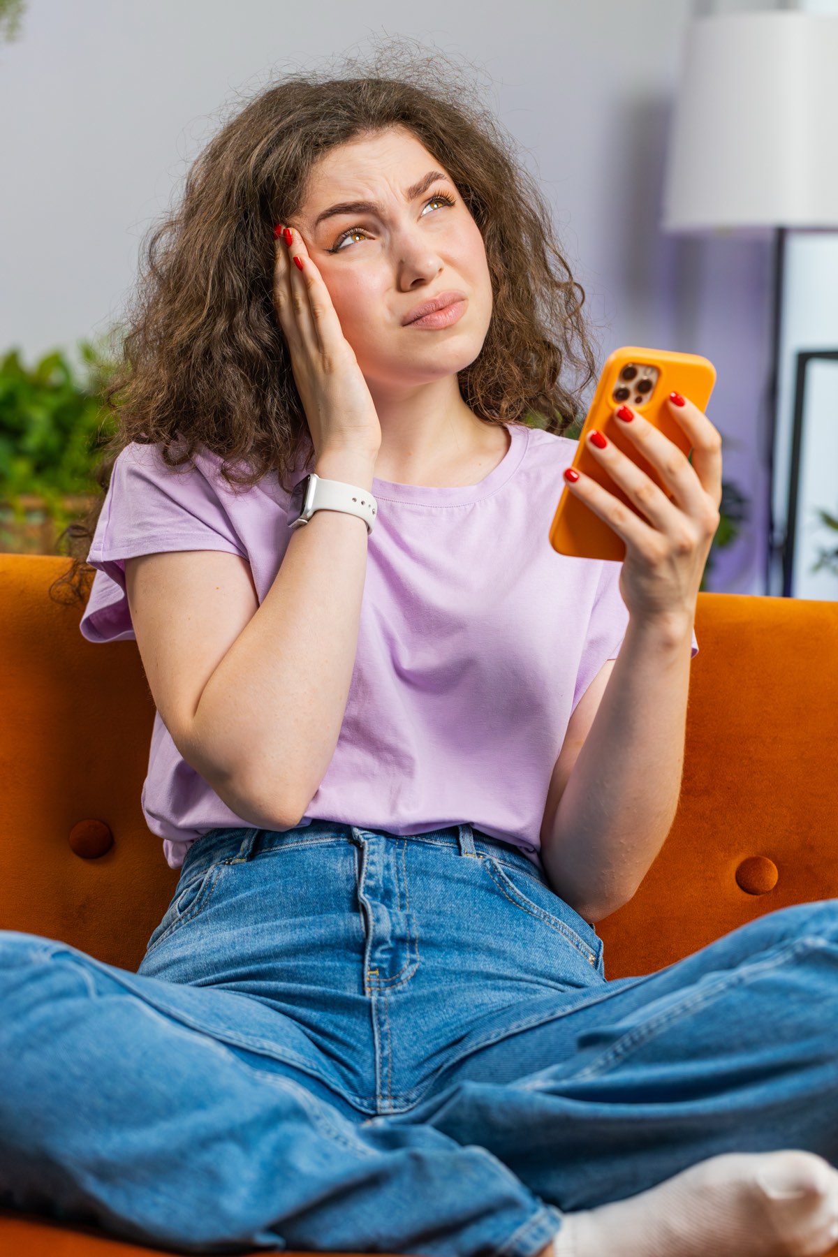 A patient at home in the evening, typing on their phone